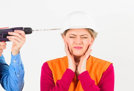 Incompetent female worker with drill on white background.の写真素材