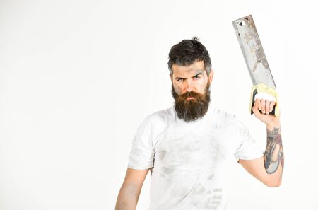 Builder, worker, carpenter, handyman holds saw or hacksaw, white backgroundの写真素材