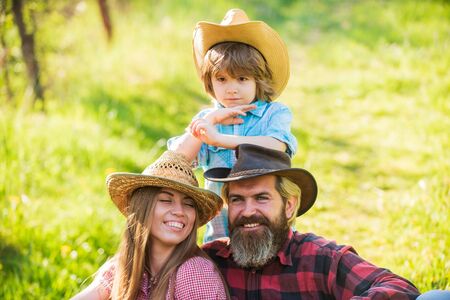 Lovely family nature background. Farmers relaxing. Reliable support for child. Family values. Good relations with family members. Happy family day. Mother father and cute son. Parents and little babyの写真素材