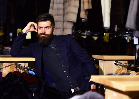 Man with beard and mustache in fur shop.