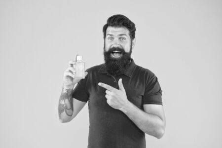 Choose perfume according occasion. Lotion spray. Perfumery products concept. Man well groomed bearded handsome hold bottle perfume. Wearing perfume. Musk aromatic substance commonly used base noteの写真素材