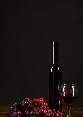 Winetasting and degustation still life concept. Grapes, bottle and wineglassの写真素材