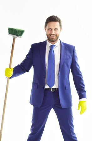 Banker or director holds cleaning supplies and smiles.の写真素材