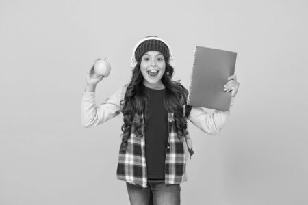 Technologies for studying. Audio courses. Technologies for learning. Modern technologies. Education and development. Little girl listening school book earphones. Study languages. Free print workbookの写真素材