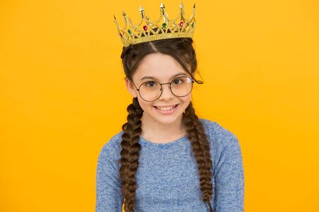 Accessorize your beauty. Little beauty queen yellow background. Beauty look of small girl. Junior...