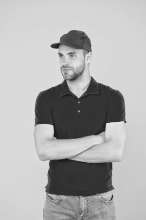 friendly shop assistant. food order deliveryman. cashier vacancy. Fast and free parcel delivery. dealer yellow wall. Salesman cashier career. man delivery service in red tshirt and capの写真素材