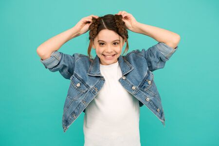 Shape your braids into gorgeous hairstyle. Happy child wear braided hairstyle blue background. Hair salon. Fashion hairstyle. Beauty look. Hair care products. Choose the right hairstyle for youの写真素材