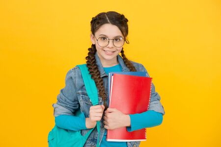 Library makes you visionary. Library reader yellow background. Happy girl hold library books. Smart...