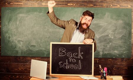Teacher or school principal welcomes inscription back to school. Teaching pupils his professional occupation. Teacher experienced tutor welcomes new enrollees to begin study and get educationの写真素材