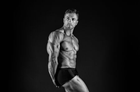 Gym is my second home. Fit man black background. Fit athlete show muscles. Strong sportsman with fit body. Staying fit and healthy, vintage filterの写真素材