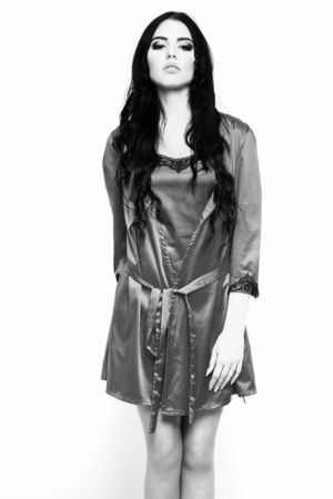 girl posing in pink silk robe isolated on white