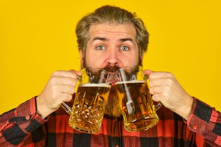 Holiday celebration. Fathers day. Birthday party concept. Alcoholic. Thirsty man drinking beer in pub bar. Beer with foam. Hipster drink beer. Mature bearded guy hold beer glass. Cheers toastの写真素材