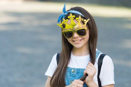 Live like you dream. Happy girl wear prop crown and glasses. Little miss beauty. Child beauty pageant crown. Party crown. Fashion accessories. Golden diadem or tiara. Big boss. Crown she deservesの写真素材