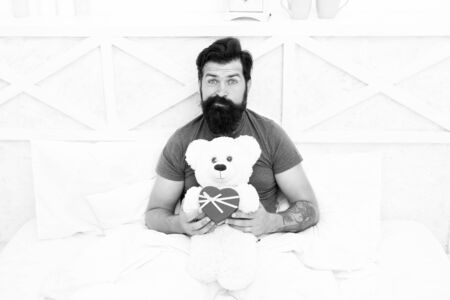 Excitement. bearded man teddy bear in bed. Gift box for holidays. nice present for you. Valentines day morning. my birthday. Happy adulthood. home shopping concept. Love and happinessの写真素材