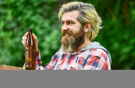 brutal hipster drinking alcohol beverage. relax after work day. bearded man has hangover. mature man drink beer. stylish man drinking from beer bottle. clear pour water. healthy water in glass bottleの写真素材