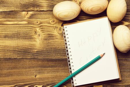 recipe and menu design, wooden eggs, paper notebook, happy easter, cooking and eating, healthy food, farming and agriculture, drawing and art, copy spaceの写真素材