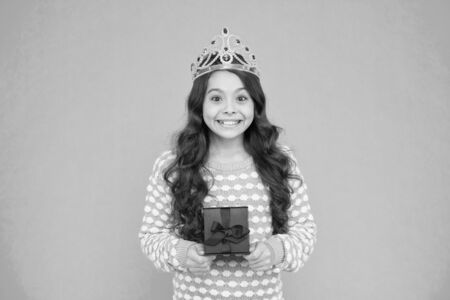 Portrait of cute smiling little girl with gift box. kid in princess crown. happy birthday daughter. Birthday Princess. Kid silver crown symbol of glory. portrait of pride. happy childrens dayの写真素材