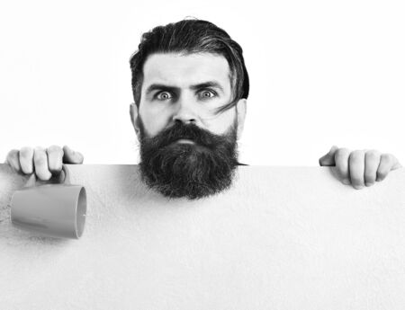 Bearded brutal caucasian hipster with paper sheet and cupの写真素材