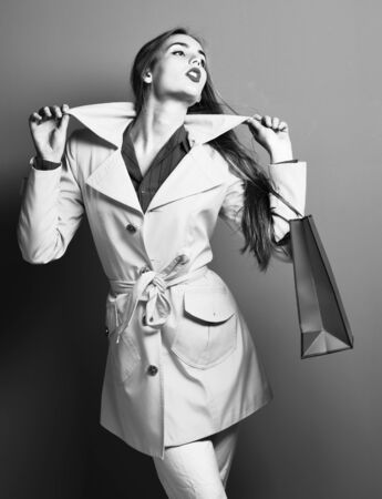 serious colorful girl with peg on red studio backgroundの写真素材