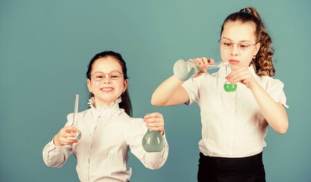 Small kid study. Education concept. Chemistry fun. Basic knowledge. Knowledge day. Schoolgirl with chemical liquids. Education concept. Safety measures. Knowledge and information. Experimenting a bitの写真素材