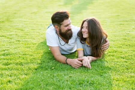 Happy summer. Happy family relax on green grass. Couple in love dating on natural landscape. Happy vacation. Family recreation. Enjoyment and relaxation. Being happy togetherの写真素材