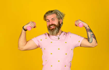 workout with barbell. male at fitness gym. practicing weight lifting. power and strength. hipster show biceps muscle. bearded guy hold heavy sport equipment. healthy sportsman. happy man use dumbbell.の写真素材