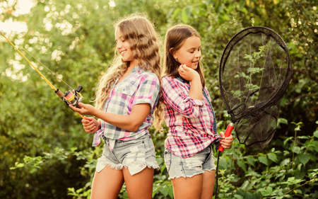 Happy childhood. Adorable girls nature background. Teamwork. Camping activities. Fly fishing. Kids...
