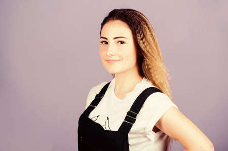 Popular look. Woman smiling face posing with stylish hairstyle on violet background. Hair crimping method styling hair becomes wavy zigzag fashion. Voluminous crimped hair. Trendy crimped hairstylesの写真素材