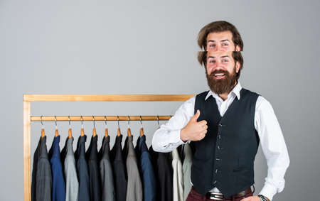 stylish business man at workspace. Fashion design studio. Male fashion designer. Individual measures hand of man. Man ordering business suit posing indoor. Tailor measures manの写真素材