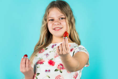 take this berry. childrens health care. healthy breakfast of little child. dieting and vitamin concept. summer berry harvest. kid love strawberry. small girl eating strawberry. healthy diet foodの写真素材