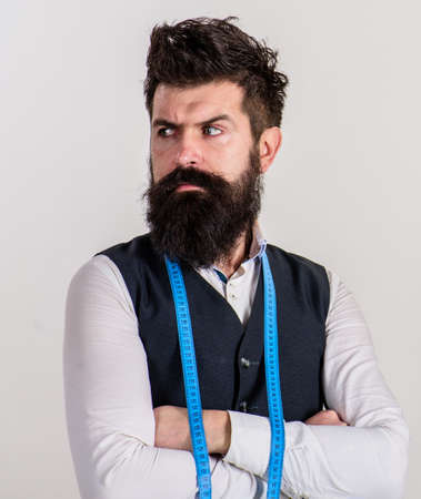 Macho in waistcoat and measuring tape around neck.の写真素材