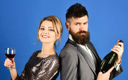 Couple in love tasting wine with smiling and serious facesの写真素材