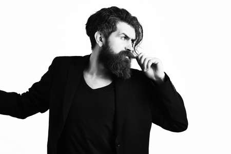 Brutal caucasian hipster in black suit on white studio background