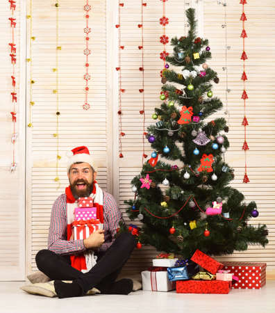 Santa Claus with cheerful face on red garlands backgroundの写真素材