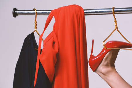 Seduction and fashion concept. Girls red shoe on wardrobe hangerの写真素材
