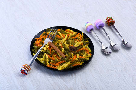 Cookies and biscuits made of clay on forks and spoonsの写真素材