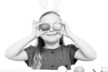 small happy baby girl with easter eggs isolated on whiteの写真素材