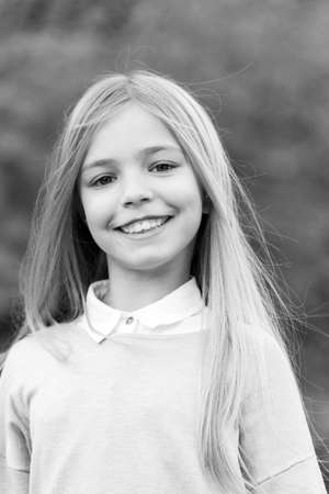 Child in grey sweater on idyllic autumn day.の写真素材