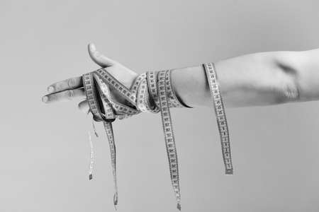 Hand with flexible rulers on light purple backgroundの写真素材