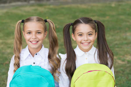 Great place to be back. Happy children back to school. Small girls wear school uniform. Back to school style. Education and study. Back to school essentials. Startup. September 1の写真素材