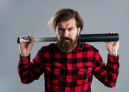 look menacing. brutal bearded man using baseball bat for fighting. man swung the bat. bandit gang...