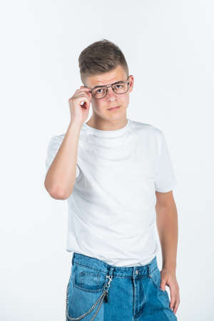 look at that. urban style. fashion model teen. teen boy wear glasses. young boy in casual style. handsome teen male isolated on white. male barbershop and hairdresser. mens beauty standardsの写真素材