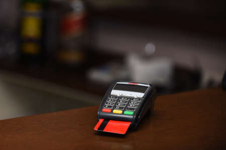 Payment with credit card. Red bankcard inserted in EDC machineの写真素材