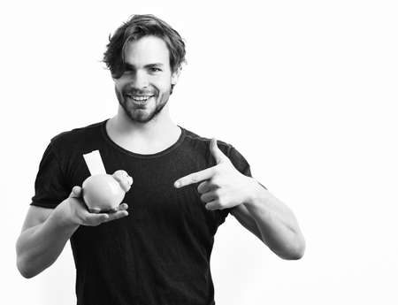 Caucasian sexy young macho holding pink piggy pig bank