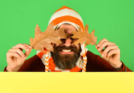 Guy with hidden smiling face wears warm hatの写真素材