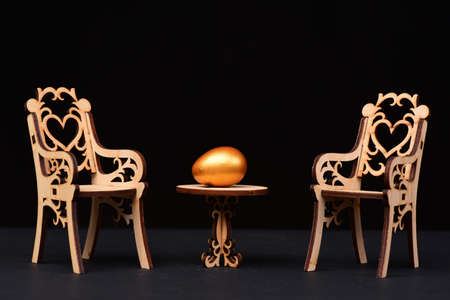 traditional egg painted in golden color on wooden tableの写真素材