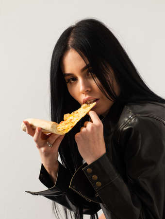 Sensual woman enjoy eating pizza.