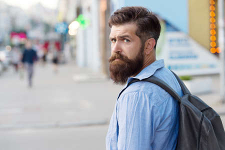 Backpack for urban traveling. Hipster backpack urban street background. Tourism and backpacking....