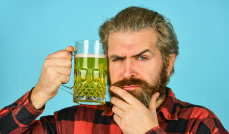Man hold a glass of beer.