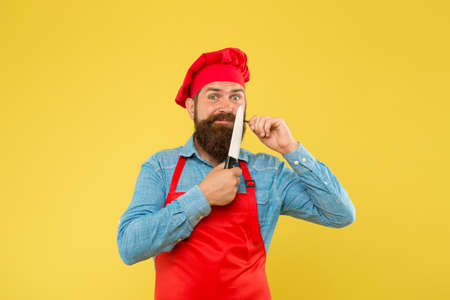 great food and service. brutal butcher in apron. best menu offer. confident bearded happy chef red uniform. Male chef cut with knife. mature hipster with happy face. satisfied bearded chefの写真素材